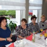 Pięć kobiet siedzi przy stole